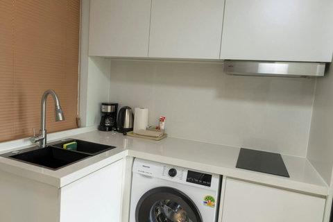 Compact kitchenette with sink, induction hob, kettle and coffee maker
