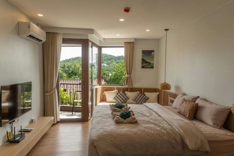 Condo interior showing Smart TV, wall AC unit and balcony doors open to the breeze