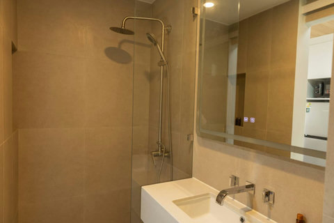 Rain shower and stone sink in the condo's private bathroom