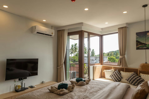 Balcony corner seat with tropical views, perfect for morning coffee in Samui