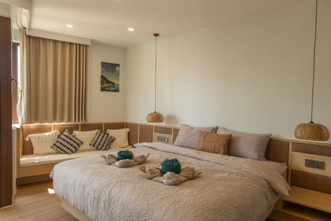Comfortable queen bed with plush pillows and a cozy corner reading nook