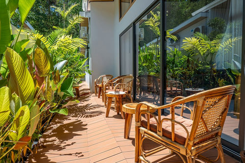 Charming outdoor rattan seating area nestled in the tropical garden.