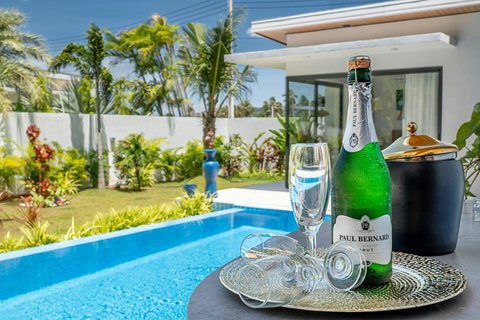 Chilled champagne and welcome setup by the private pool and sunny garden.