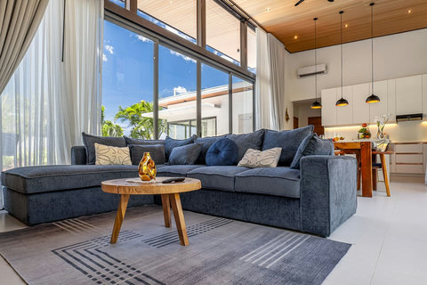 Comfortable luxury lounge area with plush seating, modern decor, and garden views.