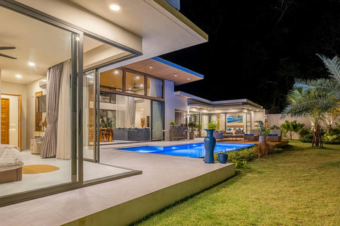 Crystal clear private swimming pool surrounded by modern luxury architecture.