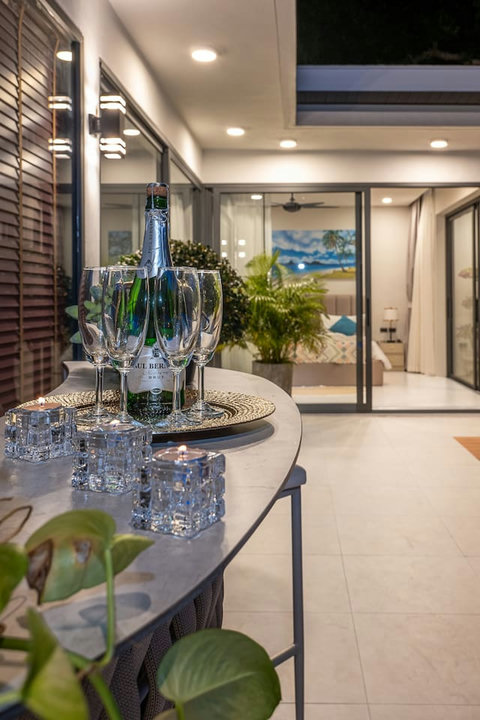 Private outdoor patio with sun loungers surrounded by lush tropical greenery.