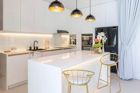 Sleek modern kitchen fully equipped with premium appliances and breakfast island.