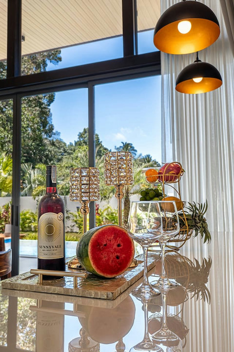 Elegant welcome amenities with fresh tropical fruit basket and fine wine.