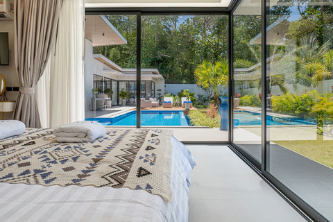 Master bedroom with direct access and view to the private swimming pool