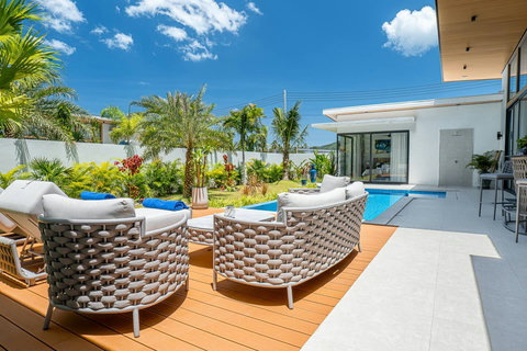 Sun loungers and comfortable patio seating by the private turquoise pool.
