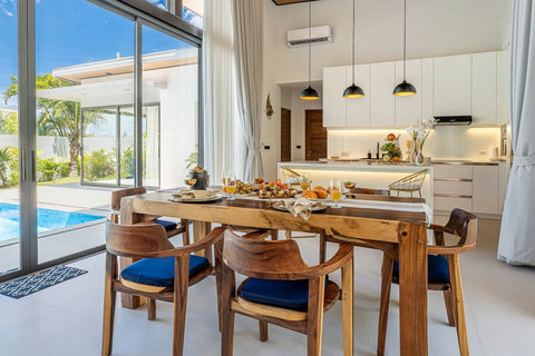 Spacious indoor dining table perfect for family meals, overlooking the pool.