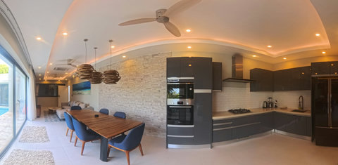 Modern kitchen and spacious dining table for enjoying meals with family and friendsl