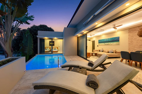 Poolside sunbeds and softly lit living spaces for relaxing evenings