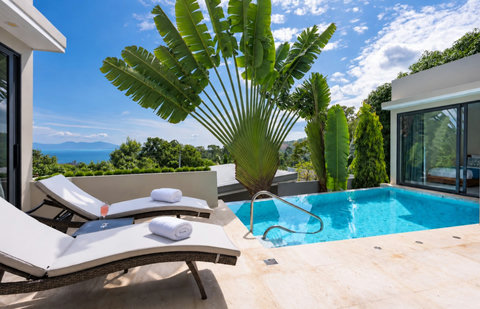 Welcome to your private tropical home, where lush gardens frame the entrance.