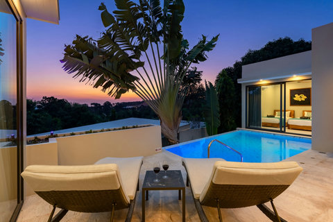 Relax by your private pool as evening settles over the villa