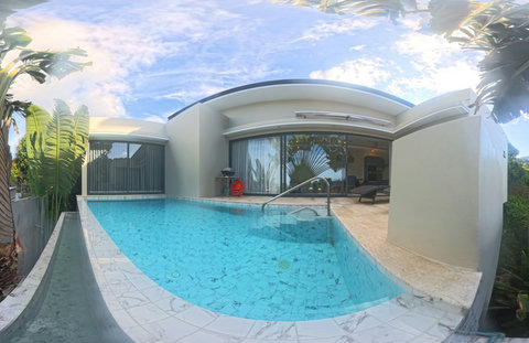 Enjoy a refreshing swim in your private pool surrounded by tropical greenery