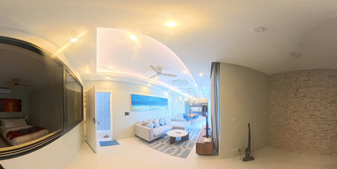 Bright ,open plan living room with comfortable sofas and a TV for relaxing together