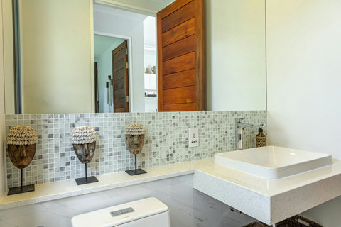 Bathroom with mosaic tile and stone basin
