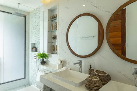 Bathroom with stone basin and rattan baskets