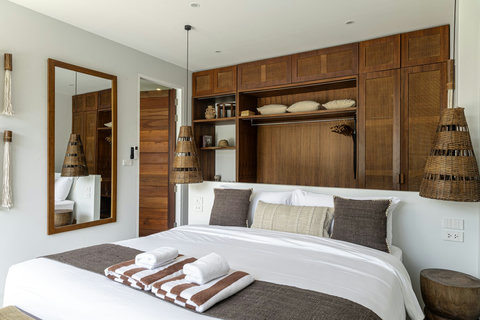 King bed with striped throw and towels