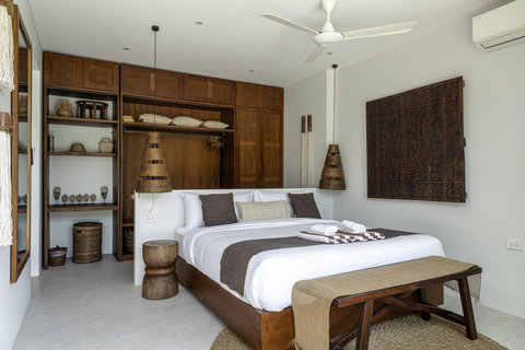Bedroom with teak wardrobe and stool