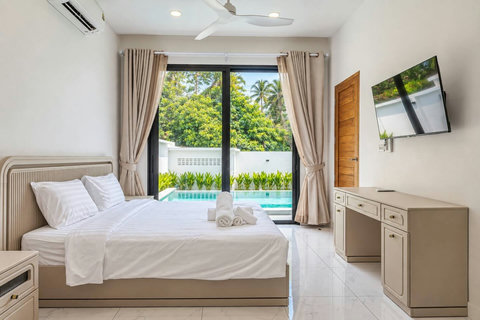 Bright and comfortable bedroom with direct access to the private pool.