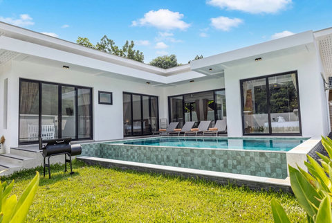 Private swimming pool surrounded by a peaceful tropical garden.