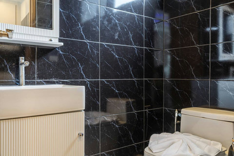 Contemporary bathroom with vanity, mirror and modern fixtures.