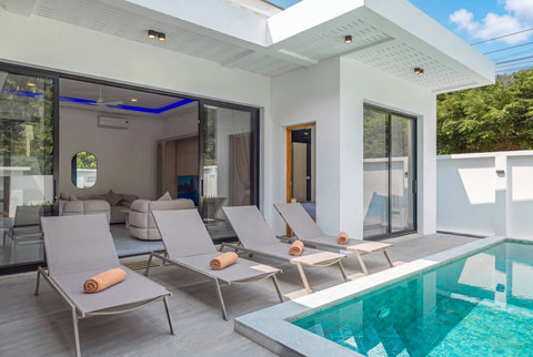 Private pool terrace with sun loungers, ideal for relaxing throughout the day.