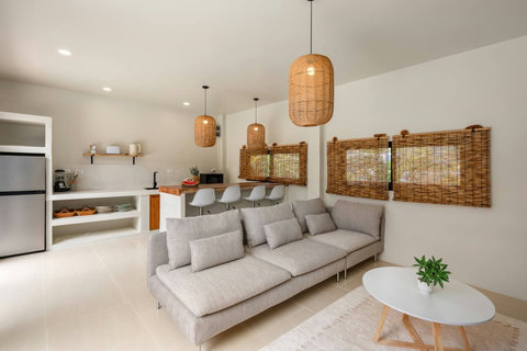 Wake up refreshed in this inviting guest bedroom with a touch of tropical warmth.