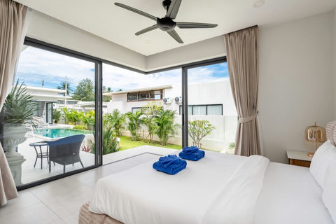 Bright bedroom with garden terrace access through floor-to-ceiling glass doors - peaceful Green Garden Villa Bophut
