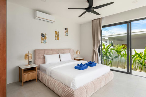 Comfortable bedroom with garden terrace view, ceiling fan and modern decor - 3-bedroom Green Garden Villa