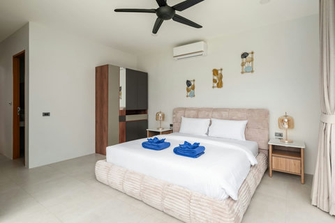Clean modern bedroom with ceiling fan, wardrobe and garden views - comfortable 3-bedroom Green Garden Villa