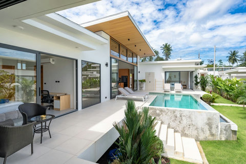 Bright open-plan living room with pool terrace access through floor-to-ceiling glass - modern Green Garden Villa Bophut