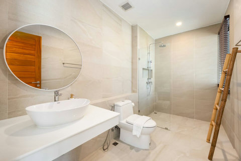 Luxurious bathroom with freestanding bathtub, modern vanity and wood accents - spa-like Green Garden Villa