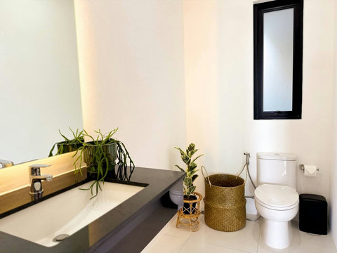 Bright modern bathroom with vanity, toilet and natural light.