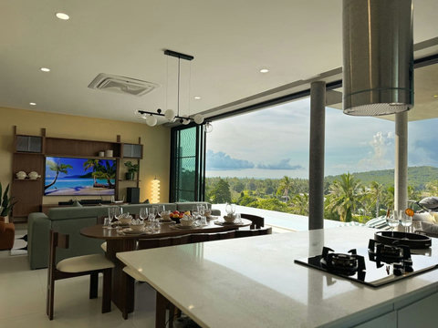 Open-plan kitchen and dining area with beautiful tropical views and plenty of natural light.