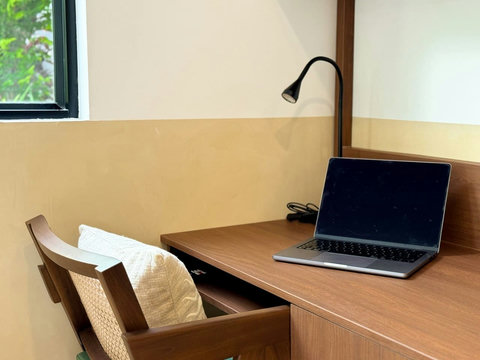 : Dedicated workspace with desk and comfortable seating, ideal for remote work.