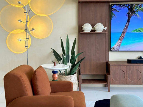 Comfortable living area with Smart TV and a warm, relaxing atmosphere.