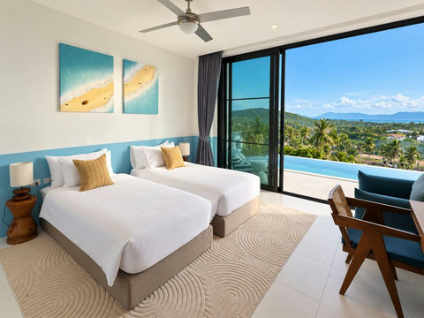 Twin bedroom opening onto panoramic tropical views and the infinity pool terrace.