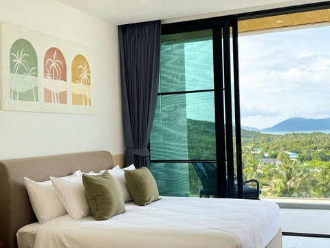 Bright sea-view bedroom with comfortable bedding and beautiful tropical views.