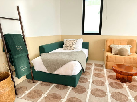 Comfortable single sleeping area with cozy seating, ideal for an additional
