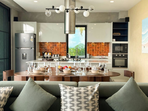 Open-plan kitchen, dining and living area with beautiful tropical views and plenty of natural light
