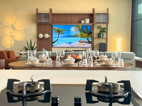 Fully equipped kitchen beside the dining area, ideal for preparing and enjoying meals together.