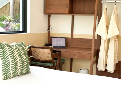Dedicated workspace with desk, storage and comfortable bedroom amenities.