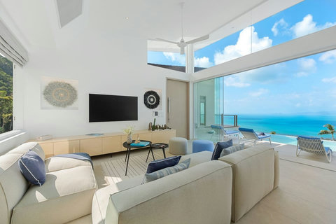 Living area with Smart TV and floor-to-ceiling sea view
