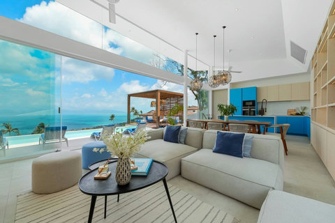 Open-plan living room that opens onto the pool and sea