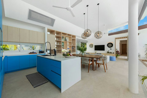 Kitchen island with dining and living beyond