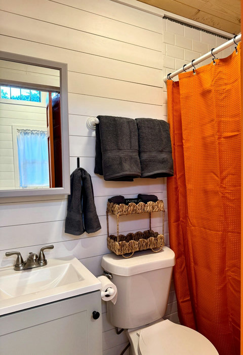 Clean, bright, and thoughtfully designed — your private bath with warm accents