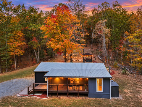 A private ridge-top setting — A wider twilight view of the Casita tucked into the trees, offering privacy, peaceful surroundings, and easy access just 5–6 minutes from Downtown Blue Ridge.